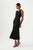 Woman wearing Crescent Knit Midi Dress by Aje, a sleeveless fit with a high ribbed neck and a curved cut out, featuring a stunning curved metal bar embellished with pearl beads and contrast curved ribbing.